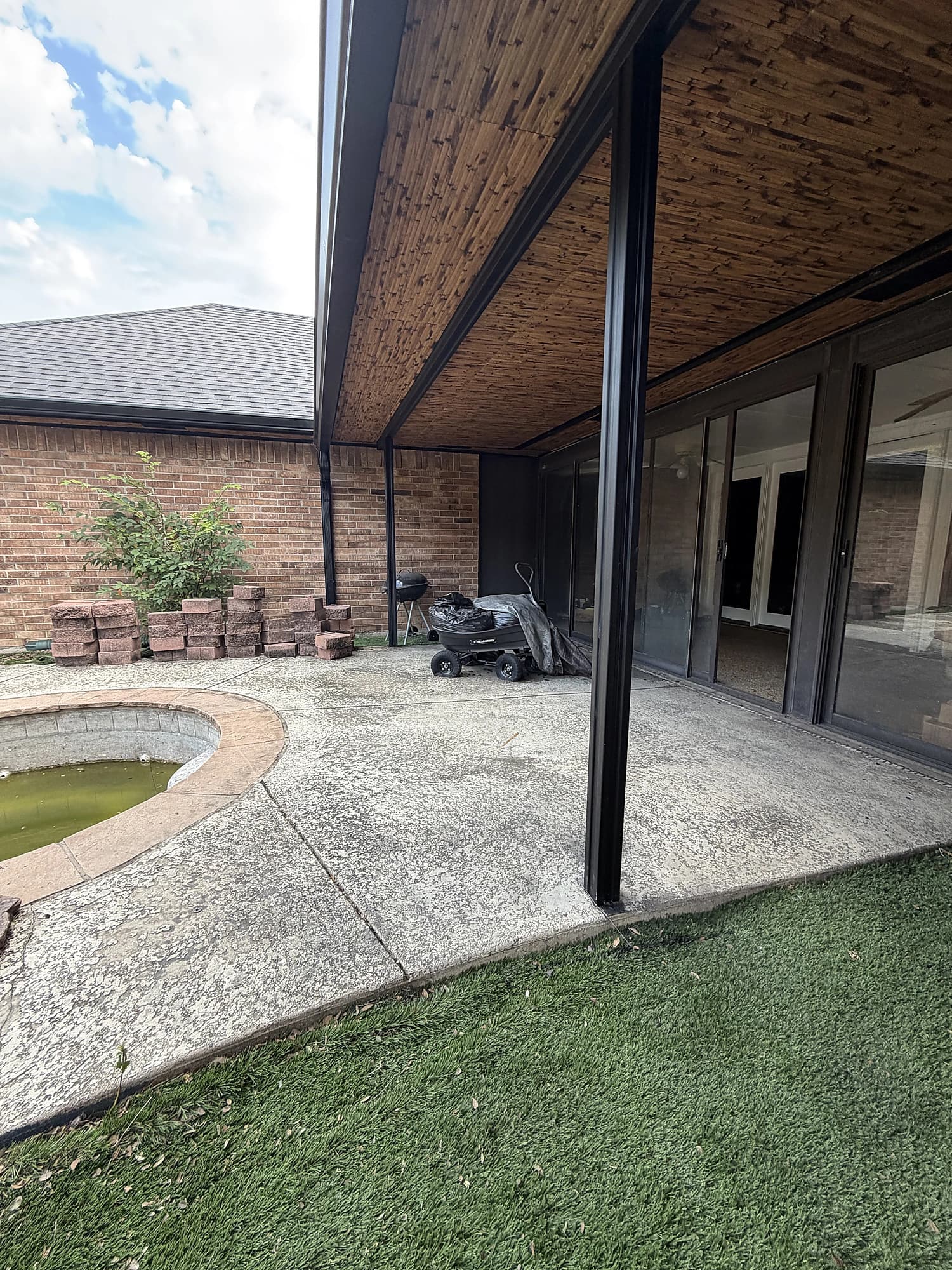 Covered patio with timber ceiling, posts, and gutter detail
