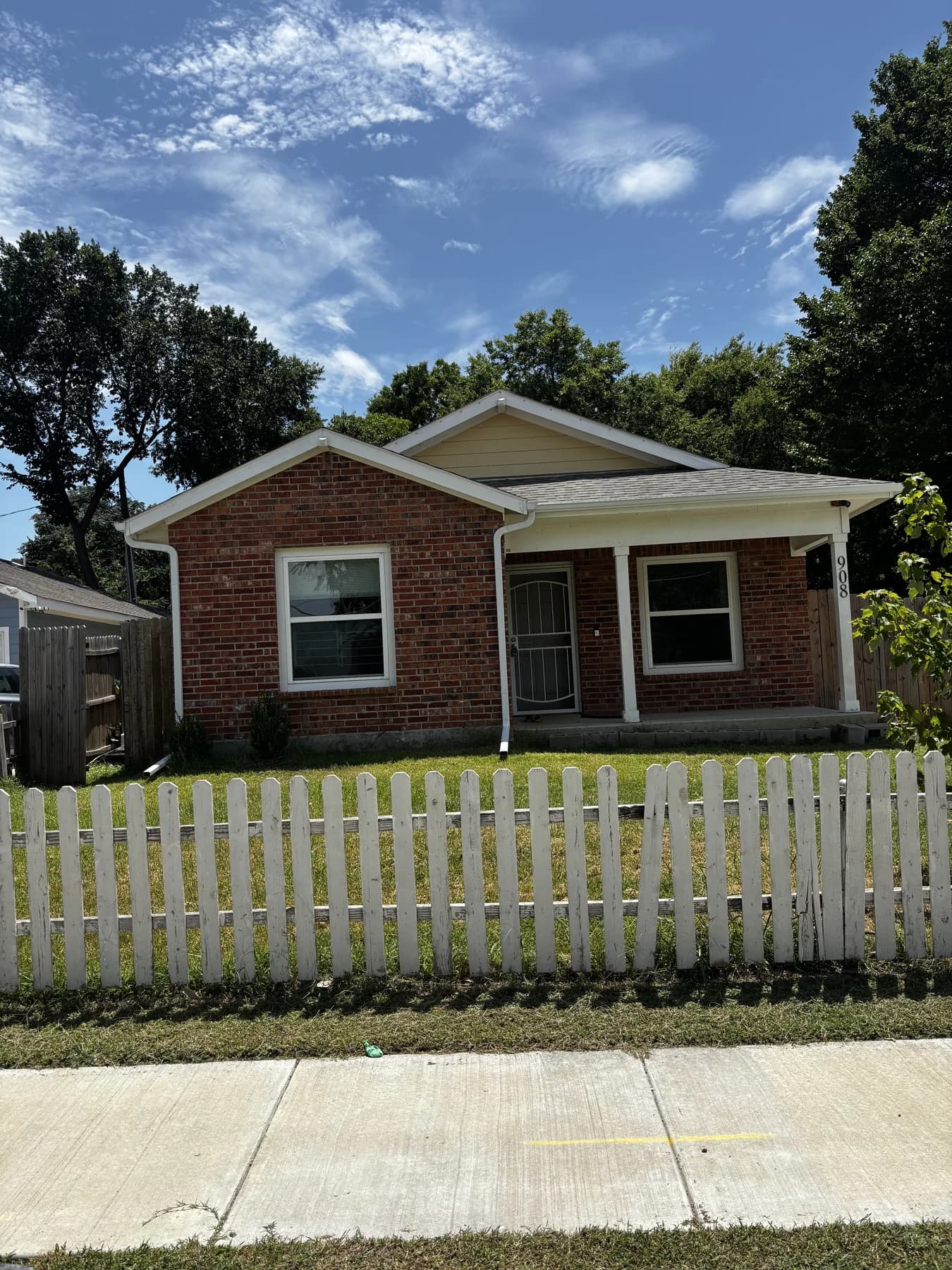 White seamless gutters installed on a red brick home